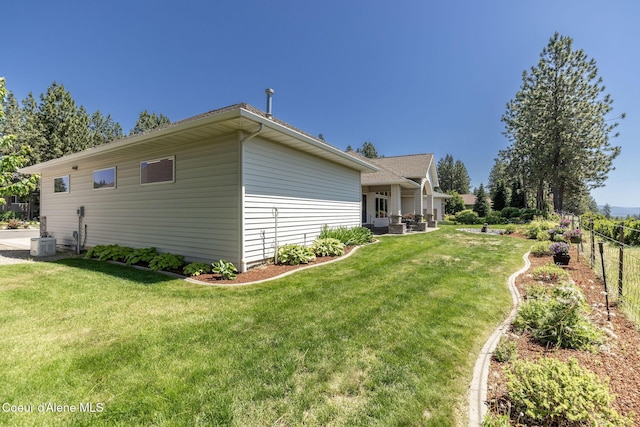 620 N Chisholm Ct, Post Falls, ID 83854 - view of side of home with a central air condition unit and a patio