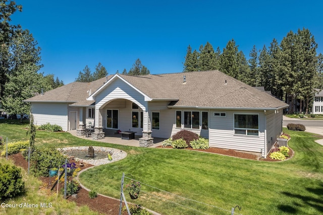 620 N Chisholm Ct, Post Falls, ID 83854 - rear view of house with a patio area, a yard, and roof with shingles