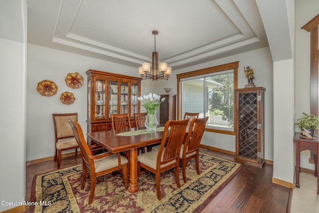 620 N Chisholm Ct, Post Falls, ID 83854 - dining area with a tray ceiling, a chandelier, and wood finished floors