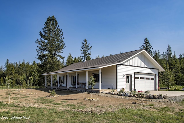 202 Elizabeth Ln, Athol, ID 83801 - view of front of home featuring a porch, metal roof, a garage, board and batten siding, and concrete driveway