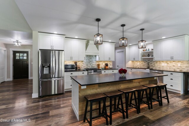 245 Lost Creek Ln, Priest River, ID 83856 - kitchen with stainless steel appliances, premium range hood, dark countertops, open shelves, and dark wood finished floors