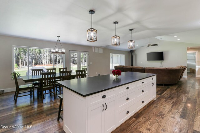 245 Lost Creek Ln, Priest River, ID 83856 - kitchen featuring dark countertops, a ceiling fan, a center island, white cabinetry, and lofted ceiling