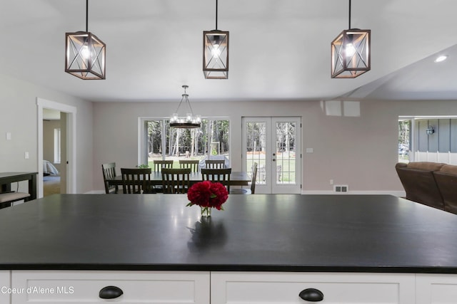 245 Lost Creek Ln, Priest River, ID 83856 - kitchen with dark countertops, open floor plan, plenty of natural light, white cabinetry, and recessed lighting