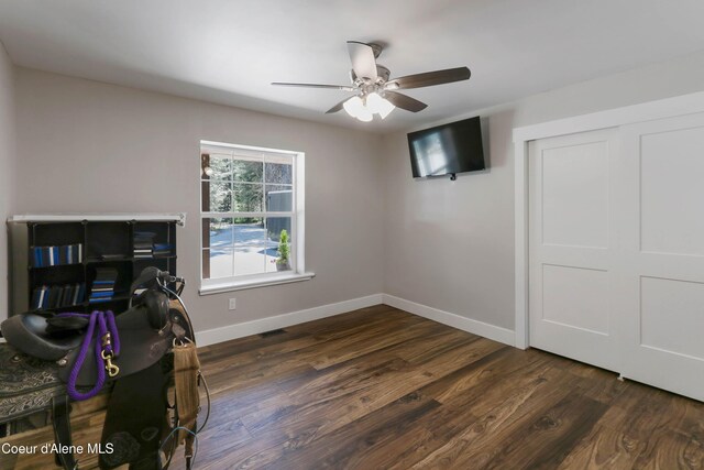 245 Lost Creek Ln, Priest River, ID 83856 - unfurnished bedroom featuring baseboards, dark wood-style floors, and a ceiling fan