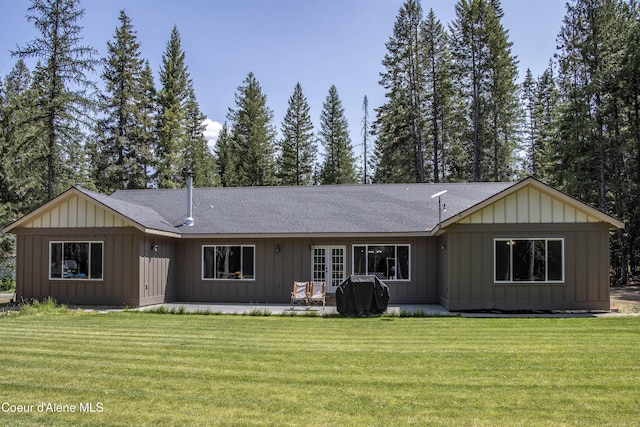 245 Lost Creek Ln, Priest River, ID 83856 - rear view of house featuring a lawn, roof with shingles, and board and batten siding