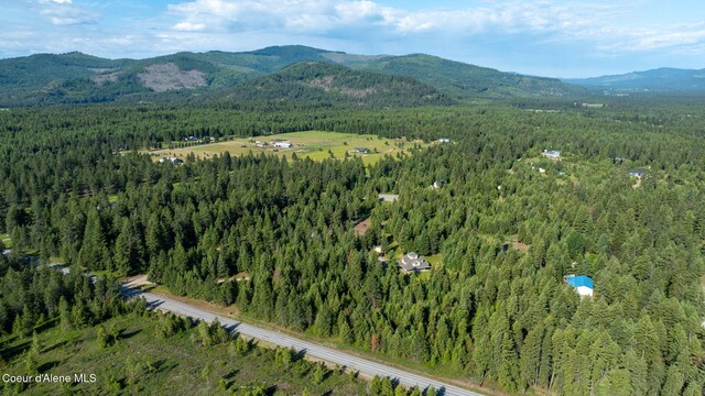 13 Park Dr, Spirit Lake, ID 83869 - aerial view of property and surrounding area featuring a forest and a mountain backdrop