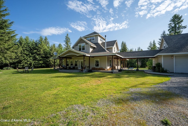 13 Park Dr, Spirit Lake, ID 83869 - farmhouse-style home featuring a front lawn, covered porch, a shingled roof, and gravel driveway