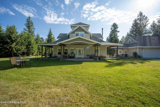 13 Park Dr, Spirit Lake, ID 83869 - rear view of house with french doors, a yard, and a shingled roof