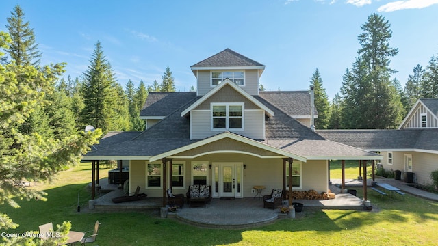 13 Park Dr, Spirit Lake, ID 83869 - back of property featuring a shingled roof, a lawn, french doors, and a patio