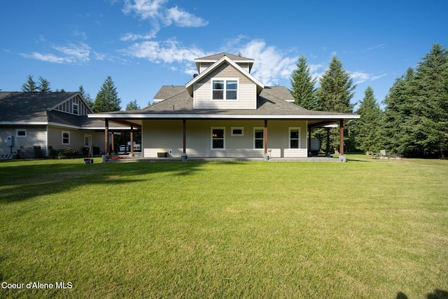 13 Park Dr, Spirit Lake, ID 83869 - back of house with a lawn, roof with shingles, and covered porch