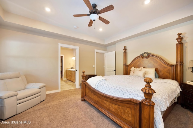 13 Park Dr, Spirit Lake, ID 83869 - bedroom with light carpet, recessed lighting, baseboards, connected bathroom, and a raised ceiling