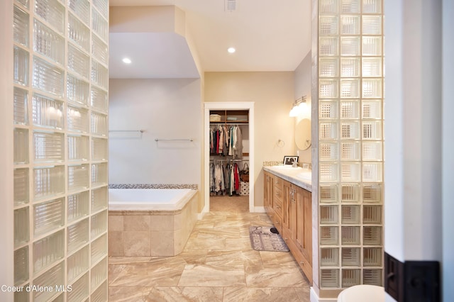 13 Park Dr, Spirit Lake, ID 83869 - full bath with vanity, a bath, a spacious closet, marble finish flooring, and recessed lighting