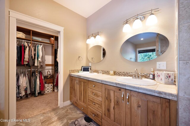 13 Park Dr, Spirit Lake, ID 83869 - bathroom featuring double vanity and a spacious closet