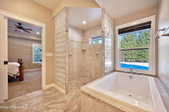 13 Park Dr, Spirit Lake, ID 83869 - ensuite bathroom with a tub with jets, a walk in shower, baseboards, and a ceiling fan