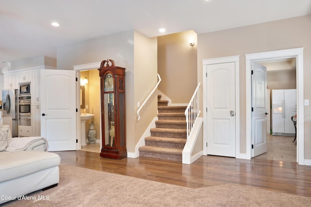 13 Park Dr, Spirit Lake, ID 83869 - living room featuring stairs, wood finished floors, baseboards, and recessed lighting
