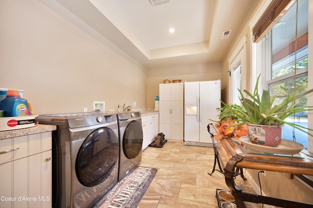 13 Park Dr, Spirit Lake, ID 83869 - laundry area with separate washer and dryer, cabinet space, light stone finish floors, and recessed lighting