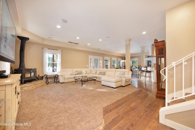 13 Park Dr, Spirit Lake, ID 83869 - living room featuring a wood stove, recessed lighting, wood finished floors, and stairway