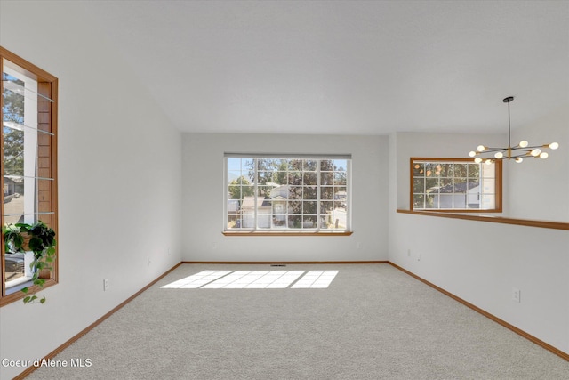 3203 N 12th St, Coeur Dalene, ID 83815 - carpeted spare room featuring a chandelier and baseboards