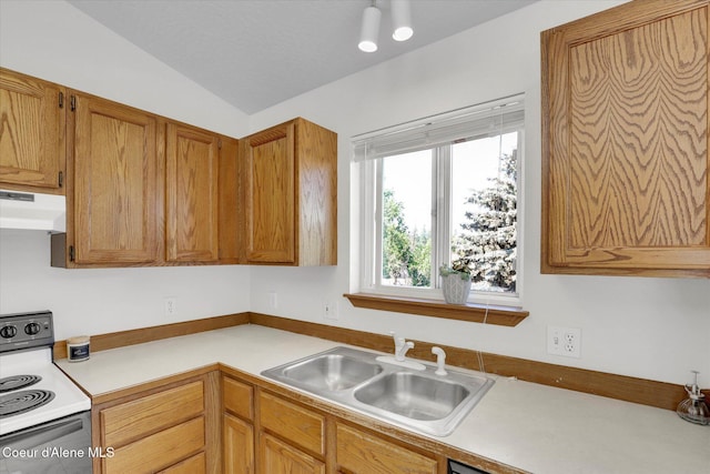 3203 N 12th St, Coeur Dalene, ID 83815 - kitchen with electric stove, under cabinet range hood, light countertops, vaulted ceiling, and brown cabinets