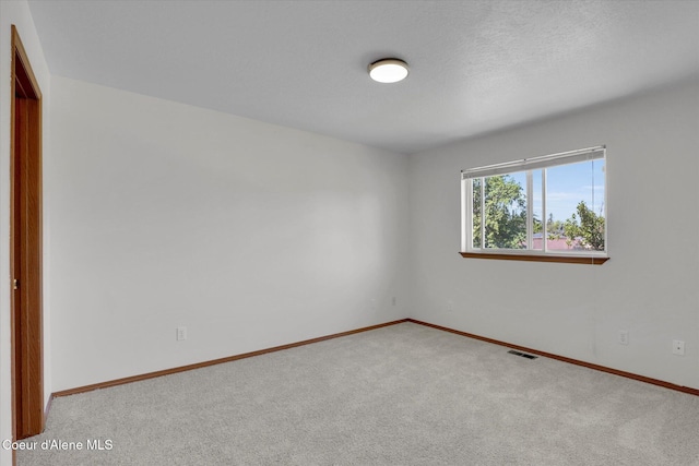 3203 N 12th St, Coeur Dalene, ID 83815 - carpeted empty room featuring baseboards
