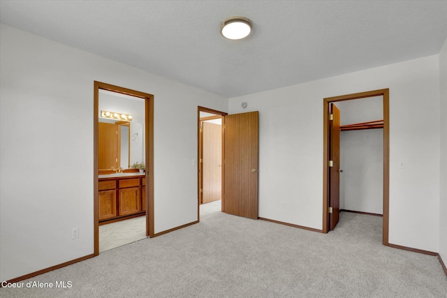 3203 N 12th St, Coeur Dalene, ID 83815 - unfurnished bedroom featuring light colored carpet, a walk in closet, ensuite bath, and a closet