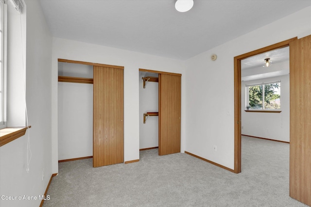 3203 N 12th St, Coeur Dalene, ID 83815 - unfurnished bedroom featuring two closets and light colored carpet