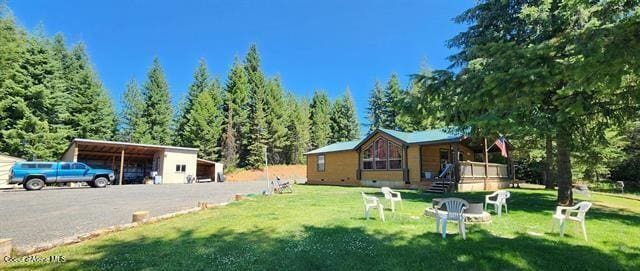 229 Henderson Lp, Kamiah, ID 83536 - view of green lawn featuring an outdoor structure and a detached carport