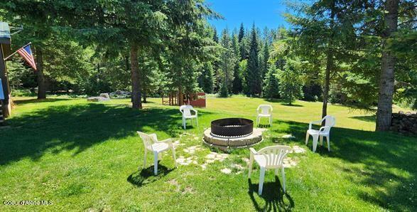 229 Henderson Lp, Kamiah, ID 83536 - view of green lawn with an outdoor fire pit