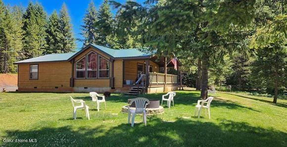 229 Henderson Lp, Kamiah, ID 83536 - view of front of property featuring crawl space, a front lawn, and a fire pit