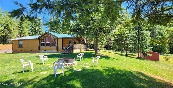 229 Henderson Lp, Kamiah, ID 83536 - view of grassy yard with an outdoor fire pit