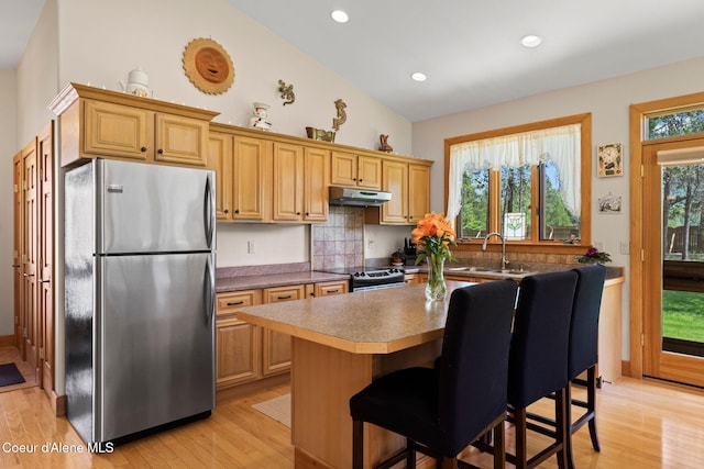 9307 Lakeshore Dr, Sagle, ID 83860 - kitchen featuring freestanding refrigerator, under cabinet range hood, electric range, light wood finished floors, and recessed lighting