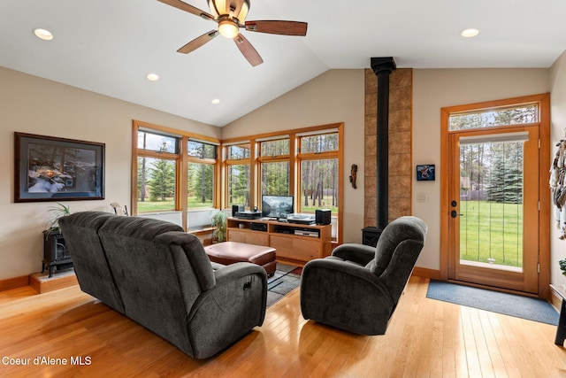 9307 Lakeshore Dr, Sagle, ID 83860 - living area with a wood stove, ceiling fan, light wood finished floors, recessed lighting, and high vaulted ceiling
