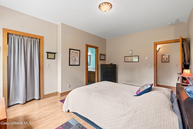 9307 Lakeshore Dr, Sagle, ID 83860 - bedroom featuring light wood-type flooring and connected bathroom