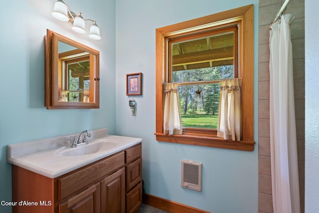 9307 Lakeshore Dr, Sagle, ID 83860 - full bath featuring heating unit, vanity, and a shower with curtain