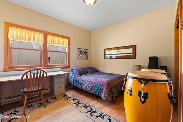 9307 Lakeshore Dr, Sagle, ID 83860 - bedroom with light wood-style flooring, a desk, and a baseboard radiator