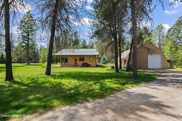 9307 Lakeshore Dr, Sagle, ID 83860 - view of green lawn with a detached garage, an outdoor structure, and driveway