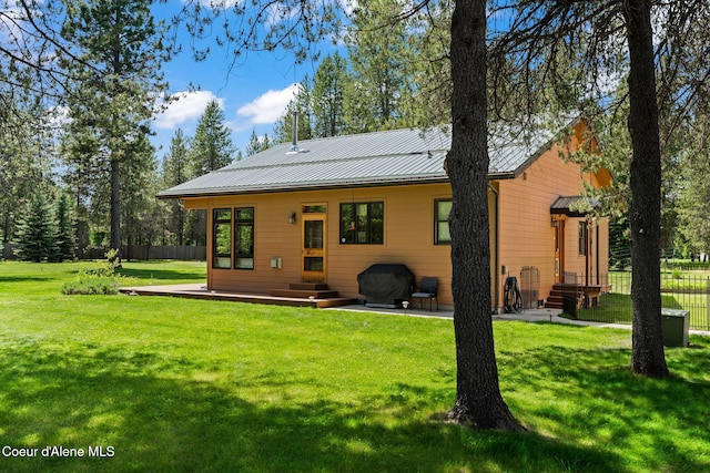 9307 Lakeshore Dr, Sagle, ID 83860 - back of house featuring a standing seam roof, a metal roof, and entry steps
