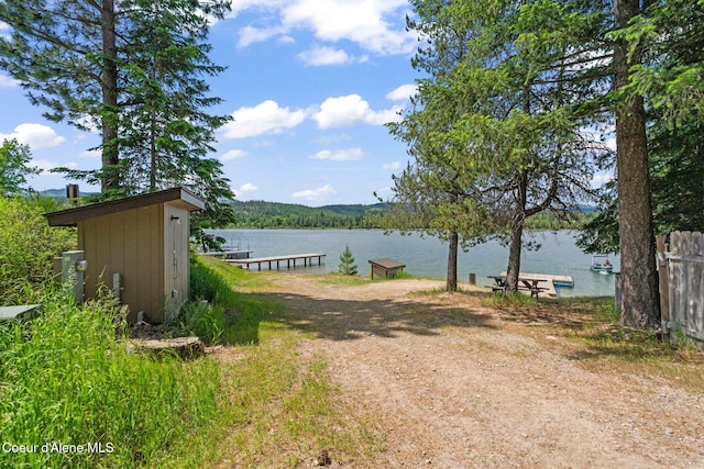 9307 Lakeshore Dr, Sagle, ID 83860 - view of yard with a water view and a boat dock