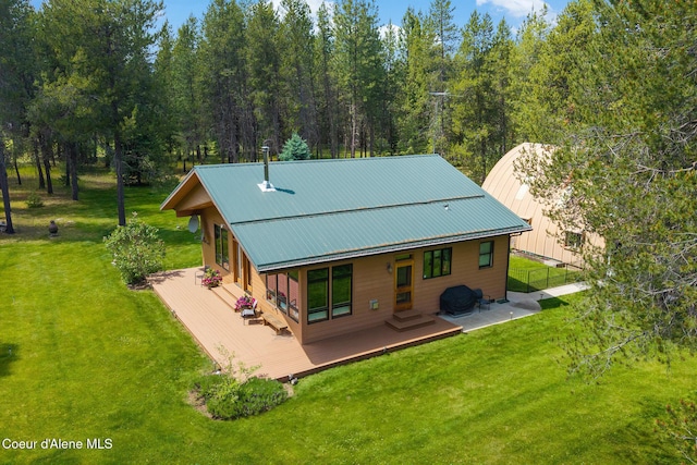 9307 Lakeshore Dr, Sagle, ID 83860 - back of house featuring a lawn, a deck, and a metal roof