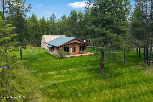 9307 Lakeshore Dr, Sagle, ID 83860 - view of front of property featuring a front lawn, a metal roof, and a view of trees