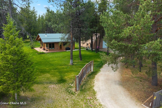 9307 Lakeshore Dr, Sagle, ID 83860 - view of front of property with dirt driveway, covered porch, and a wooded view