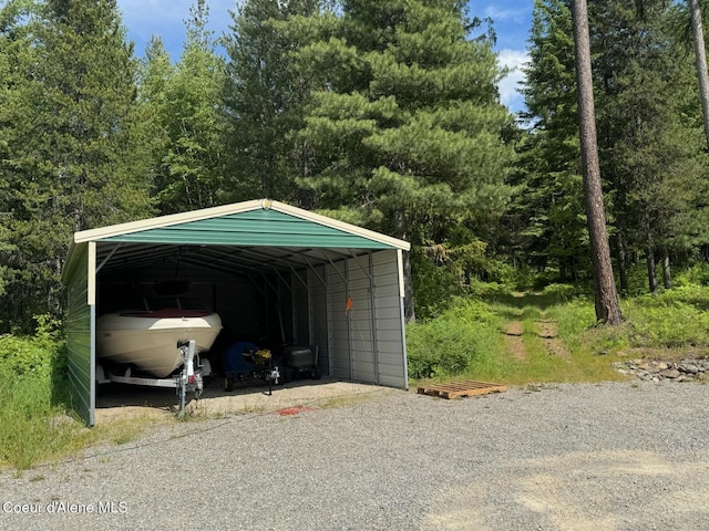 197 Berry Hl, Cocolalla, ID 83813 - view of vehicle parking with a detached carport and gravel driveway
