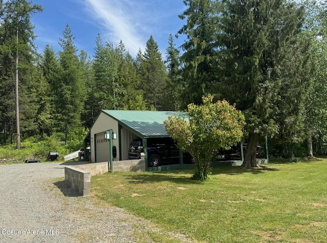 197 Berry Hl, Cocolalla, ID 83813 - view of front of house with a detached garage, a front lawn, an outbuilding, and a metal roof