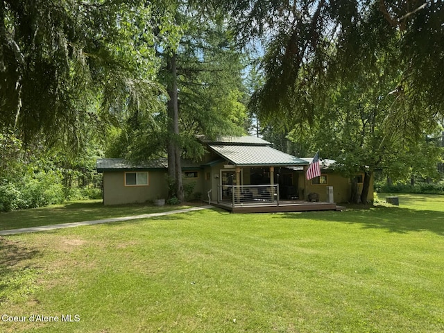 197 Berry Hl, Cocolalla, ID 83813 - back of house featuring a yard, a deck, and a metal roof