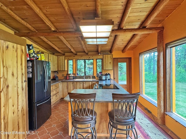 197 Berry Hl, Cocolalla, ID 83813 - kitchen featuring black appliances, wooden ceiling, light brown cabinets, and a kitchen bar