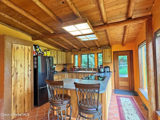 197 Berry Hl, Cocolalla, ID 83813 - kitchen featuring freestanding refrigerator, black electric stovetop, a peninsula, dark countertops, and wooden ceiling