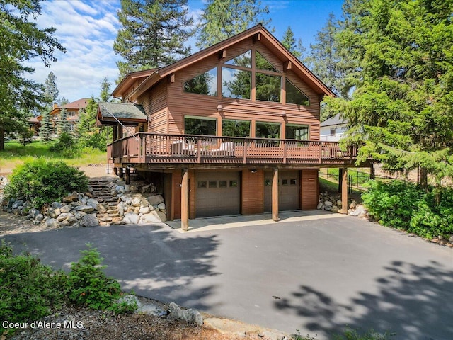 106 Stewart Dr, Blanchard, ID 83804 - rustic home with an attached garage, asphalt driveway, and a wooden deck