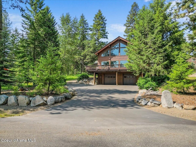 106 Stewart Dr, Blanchard, ID 83804 - view of front of house with driveway, a garage, and a deck