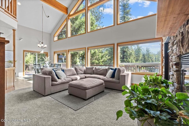 106 Stewart Dr, Blanchard, ID 83804 - living room featuring high vaulted ceiling, a chandelier, beam ceiling, tile patterned floors, and a fireplace
