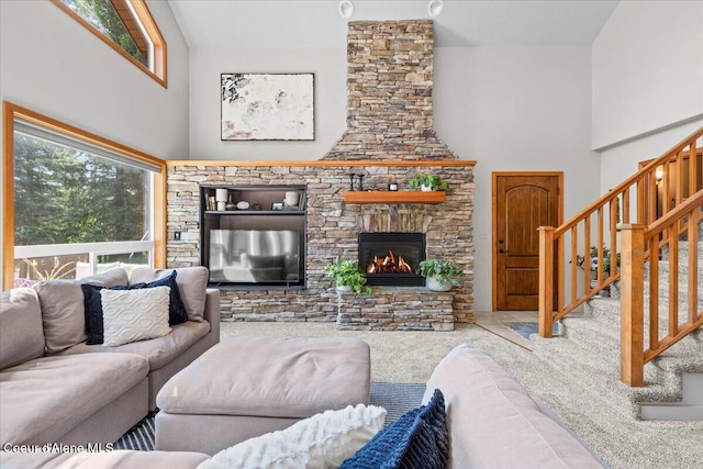 106 Stewart Dr, Blanchard, ID 83804 - living room featuring carpet, plenty of natural light, a fireplace, stairs, and a towering ceiling